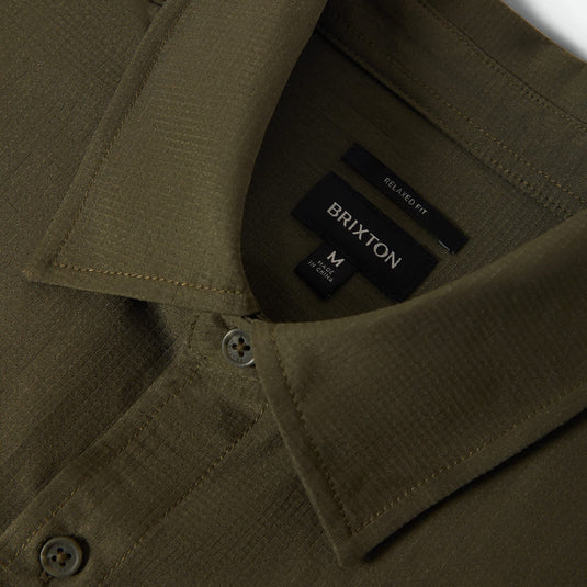 Close-up of a dark olive green collar button up shirt