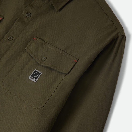Dark olive green long sleeve shirt with a pocket and small brixton patch logo 