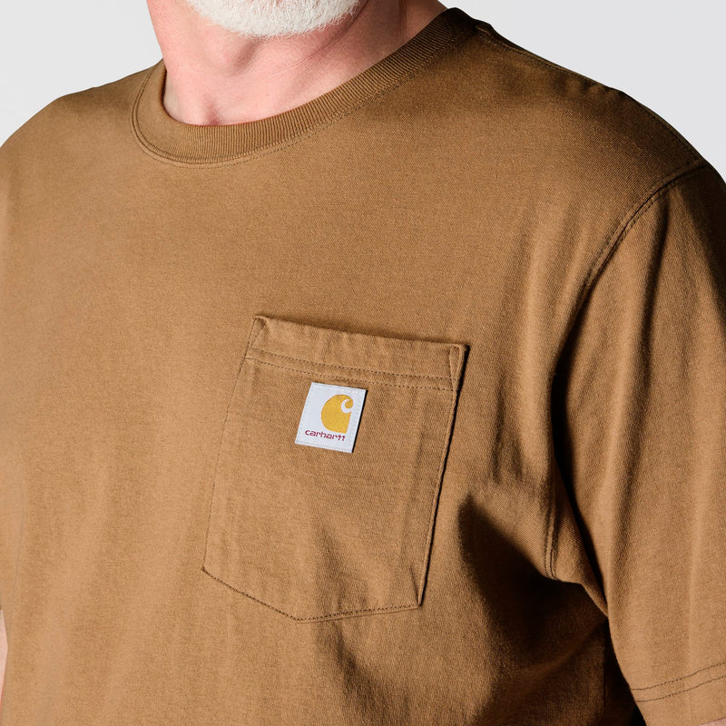 Load image into Gallery viewer, Man wearing a brown t-shirt with a Carhartt logo on the left chest pocket 
