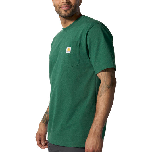 Man wearing a green t-shirt with a Carhartt brand logo on left chest pocket