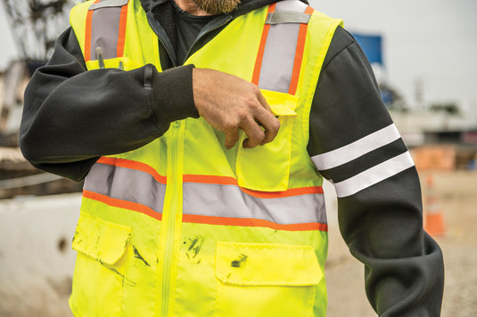 A person wearing a Kishigo 1164 UltraCool Solid Front, Mesh Back Safety Vest in a lime color
