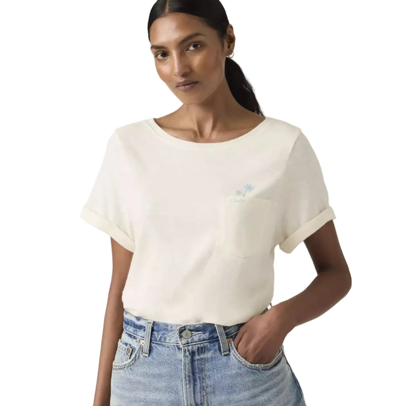 Load image into Gallery viewer, Woman wearing a white t-shirt with a small daisy embroidery detail over the left chest pocket and blue jeans
