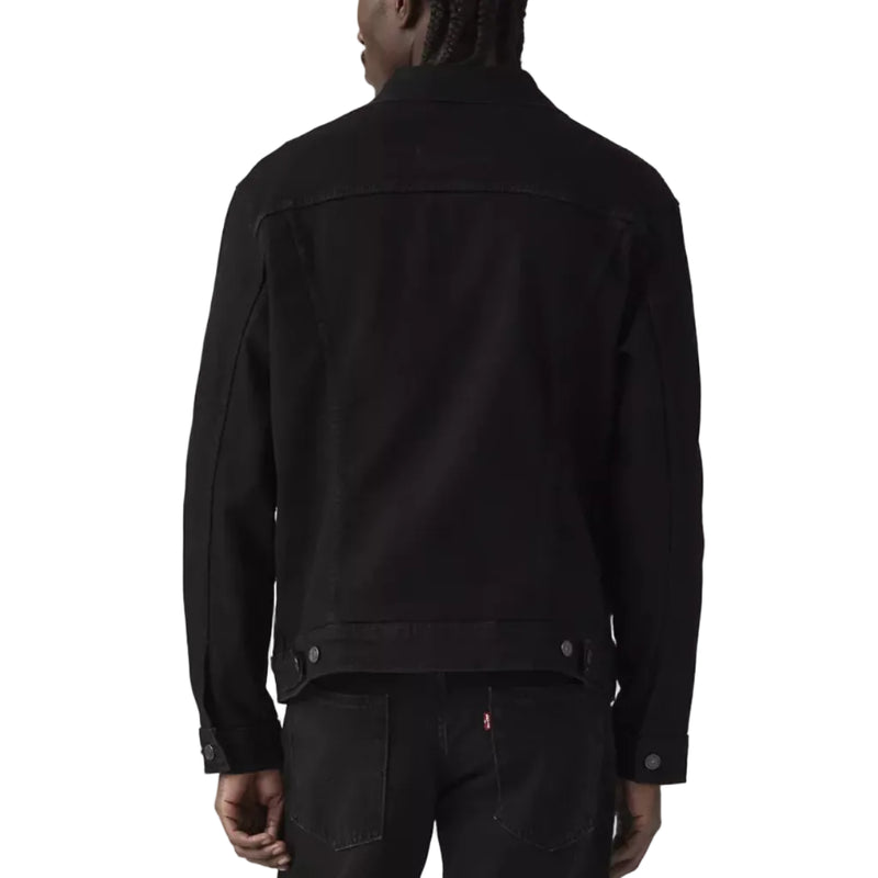 Load image into Gallery viewer, Person on a black Levi's trucker jacket on a white background. 
