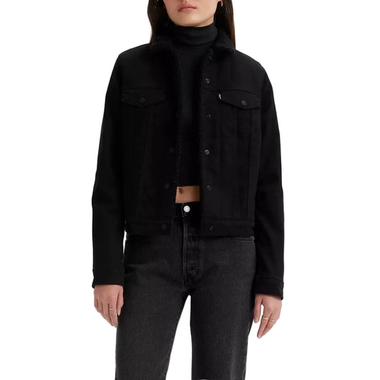Person wearing a black sherpa lined trucker jacket and turtleneck on a white background