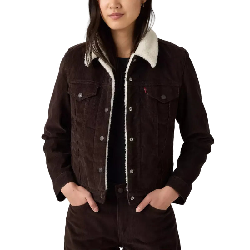 Load image into Gallery viewer, A woman modeling a dark brown denim jacket with a cream sherpa collar, paired with matching dark brown corduroy pants, against a white studio background.
