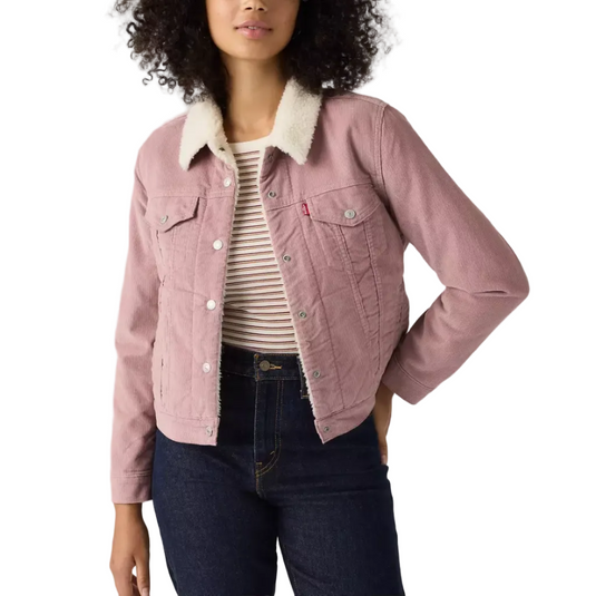 A woman modeling a dusty pink corduroy jacket with a cream sherpa collar, worn over a striped t-shirt and dark blue jeans against a white studio background.