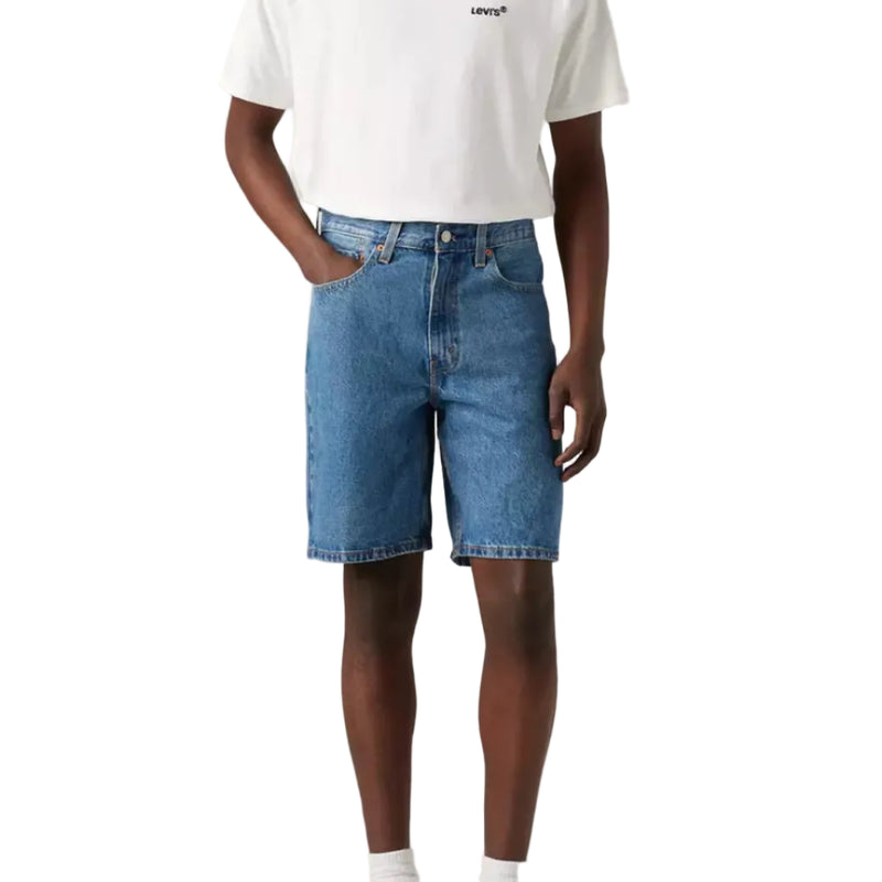 Load image into Gallery viewer, Man wearing a white t-shirt and blue denim shorts on a plain background
