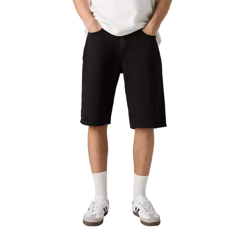 Load image into Gallery viewer, Person in black denim shorts and a white shirt on a white background. 
