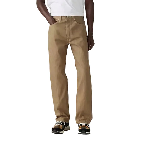 Man wearing a white t-shirt and beige shrink-to-fit jeans on a plain white background
