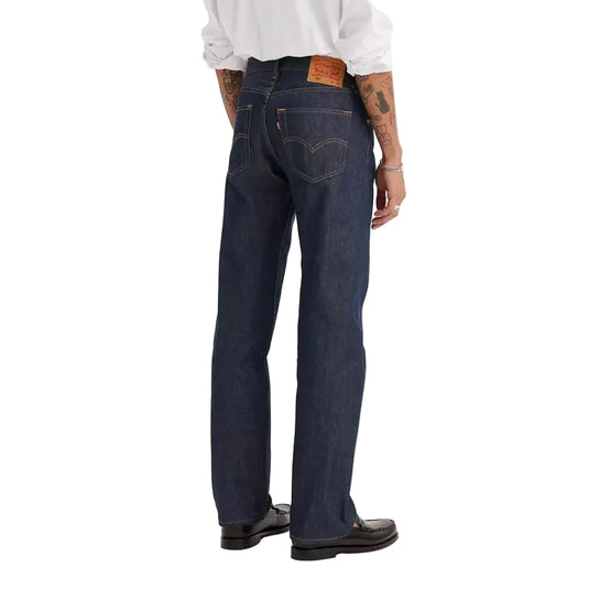 Person wearing a white shirt and dark jeans on a white background