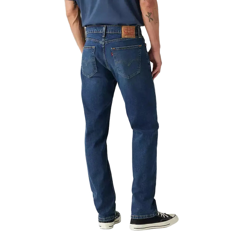 Load image into Gallery viewer, Man wearing a blue t-shirt and jeans on a plain background
