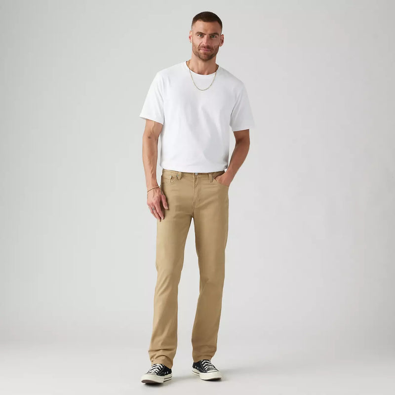 Load image into Gallery viewer, Man wearing a white t-shirt and beige pants on a plain background
