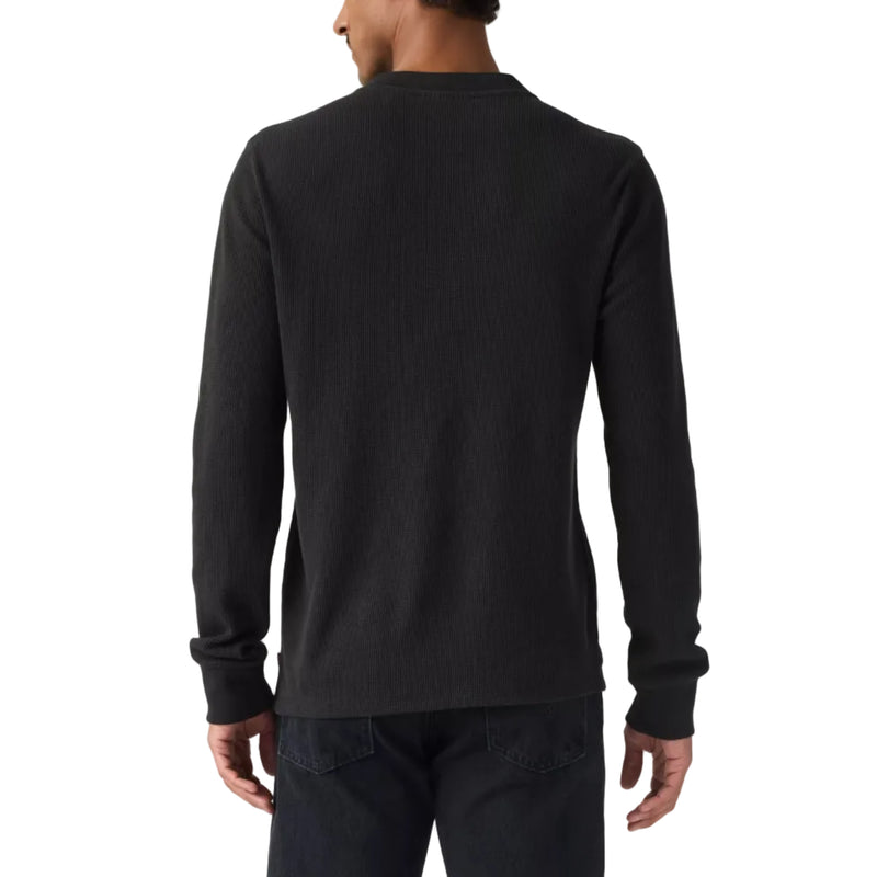 Load image into Gallery viewer, A man viewed from the back wearing a plain black long-sleeve crewneck shirt and dark jeans, standing against a white studio background.
