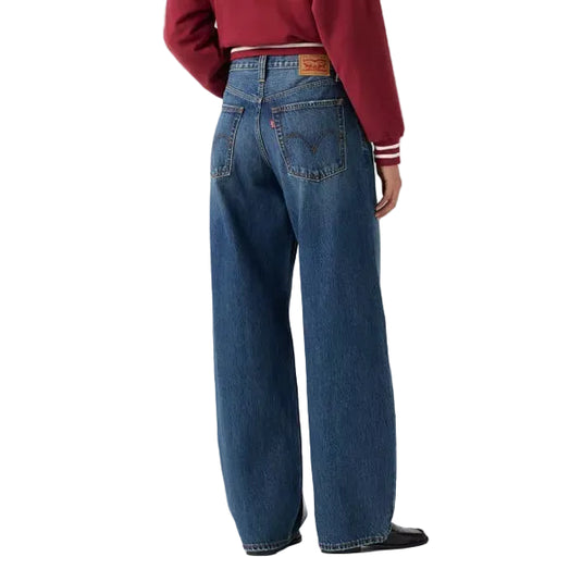 Back shot of woman wearing Levis Middy Balloon Jean in the Fixed Down colorway with a medium blue wash on a white background