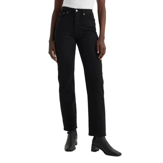 Person wearing black jeans and black shoes on a white background