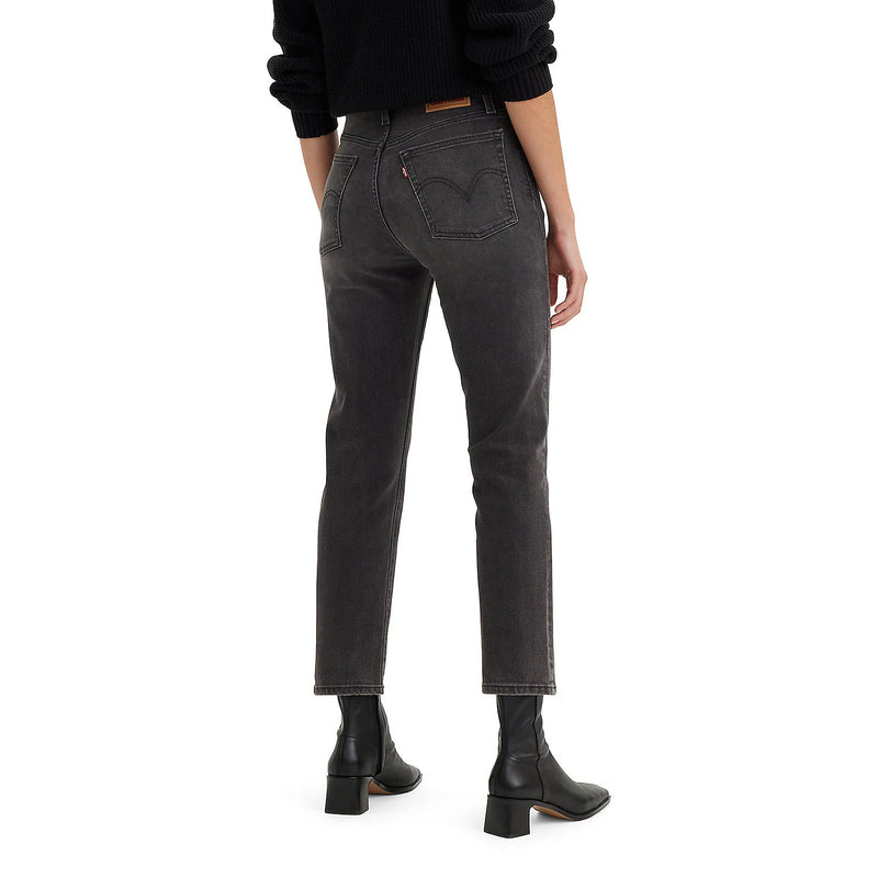 Load image into Gallery viewer, Person wearing high-waisted black jeans on a white background
