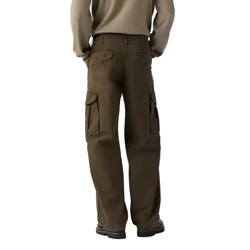 Load image into Gallery viewer, A model shown from the back wearing a beige knit sweater and dark brown cargo pants against a plain white studio background.
