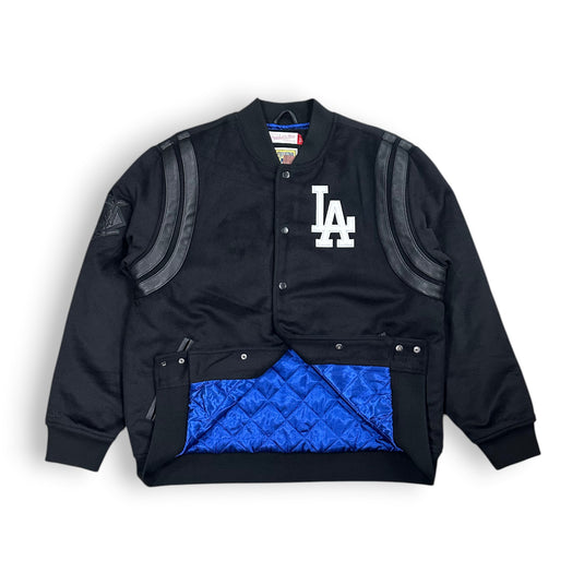Black jacket with blue quilted lining and LA Dodgers logo on a white background