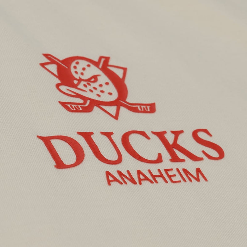 Load image into Gallery viewer, Close-up of a white fabric surface with an orange embroidered Ducks Anaheim logo and text.
