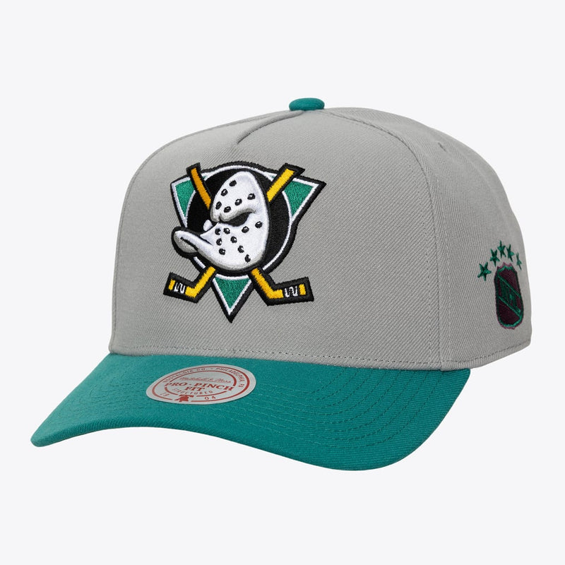 Load image into Gallery viewer, A gray and teal hockey cap featuring an embroidered Anaheim Ducks logo on the front and a Mitchell &amp; Ness brand sticker on the brim.
