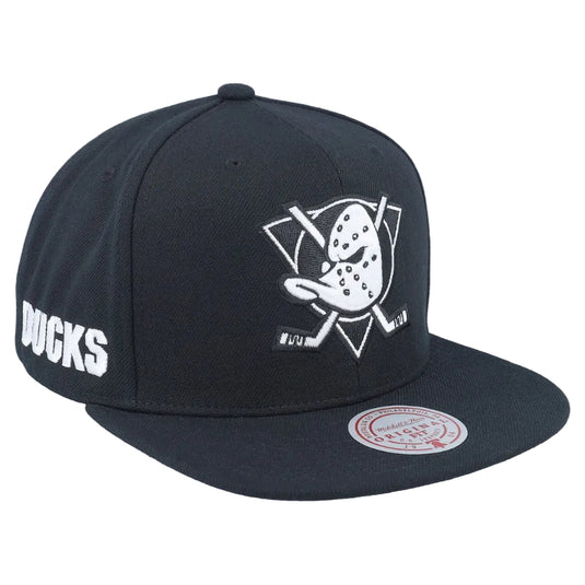 A black flat-brim snapback cap featuring the Pittsburgh Penguins logo embroidered in white on the front, 'DUCKS' in white on the side, and a Mitchell & Ness brand sticker on the brim.