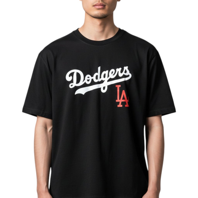 Load image into Gallery viewer, Person wearing a black Los Angeles Dodgers logo shirt on a white background. 
