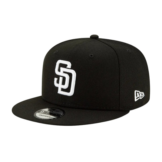 A black flat-brim baseball cap featuring a white embroidered 'SD' logo on the front and a white New Era flag logo on the side, displayed on a clean white background.