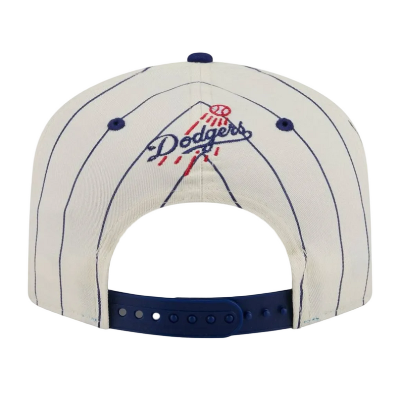 Load image into Gallery viewer, The back of a white pinstripe Los Angeles Dodgers snapback cap, featuring the embroidered Dodgers logo in navy blue and red on the crown, with a navy blue adjustable strap at the bottom.

