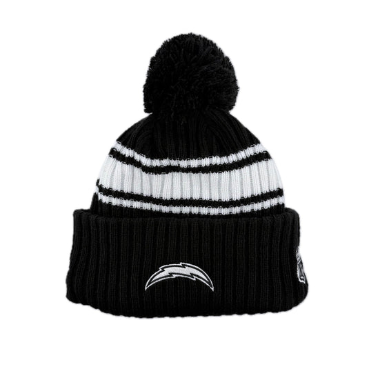 The back of the New Era NFL AFC Chargers 2022 Sideline CW black and white knit beanie with black pom-pom and team logo on the cuff and partail view of the NFL League logo on the side. 