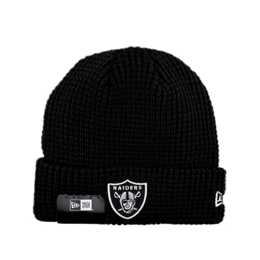 Black knit beanie with NFL team Raiders logo on the cuff and New Era logo on the side. 
