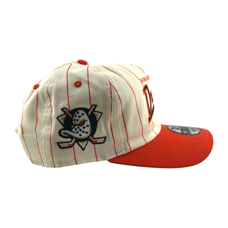 Load image into Gallery viewer, An off-white baseball cap with thin orange pinstripes, featuring an embroidered Anaheim Ducks hockey goalie logo on the front and a bright red curved brim.
