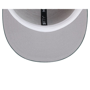 Load image into Gallery viewer, Close-up of the underside of a light gray snapback cap, showing the gray fabric brim, white inner band, and a black interior label with white text.
