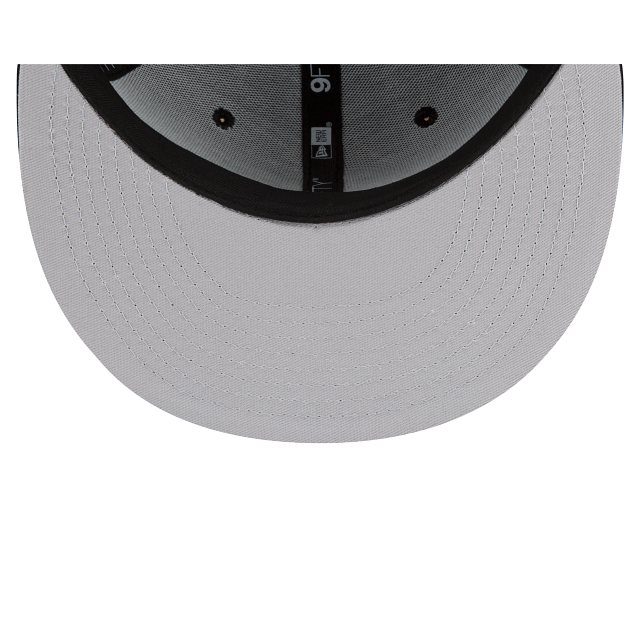 Load image into Gallery viewer, Close-up of the underside of a light gray baseball cap brim, showing black stitched edge and ventilation eyelets, with a small New Era logo visible on the center band.
