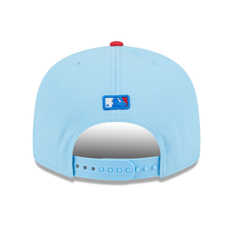 Load image into Gallery viewer, Back of a light blue baseball cap with the MLB logo above the snapback closure. 
