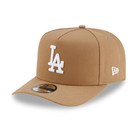 A tan Los Angeles Dodgers baseball cap by New Era, featuring a white embroidered 'LA' logo on the front and a white New Era flag logo on the side, set against a plain white background.