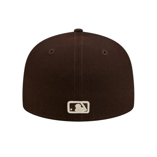 A dark brown baseball cap with a silver and white MLB logo patch on the front, shown against a plain white background.