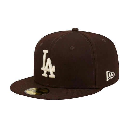 A dark brown Los Angeles Dodgers New Era 59FIFTY fitted cap with cream embroidered 'LA' logo on the front and a white New Era flag logo on the side, shown on a plain white background.