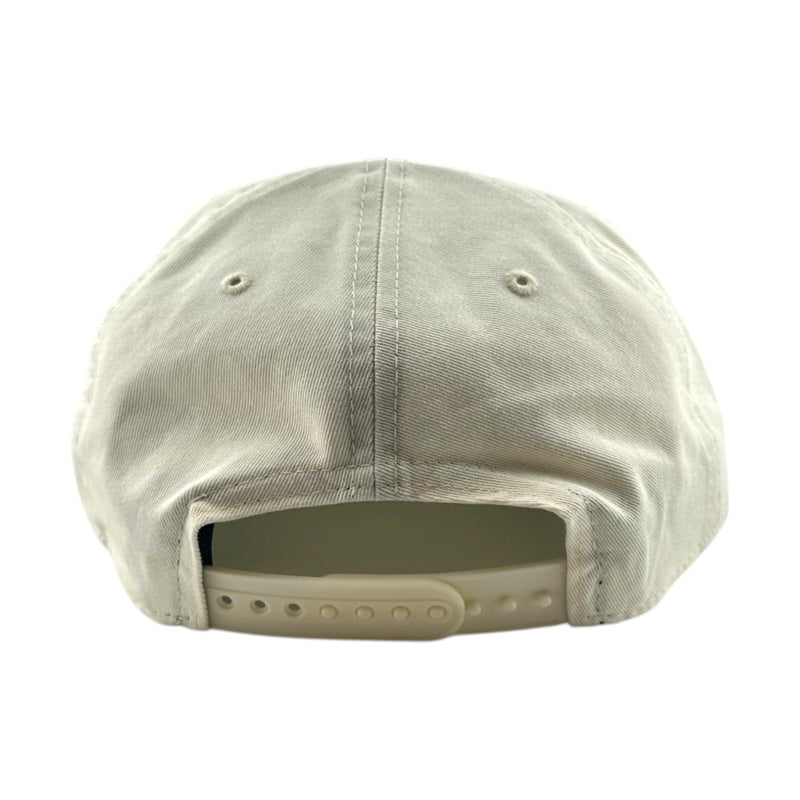 Load image into Gallery viewer, The back view of a light beige or off-white baseball cap with a fabric crown and an adjustable plastic snap closure, shown on a plain white background.
