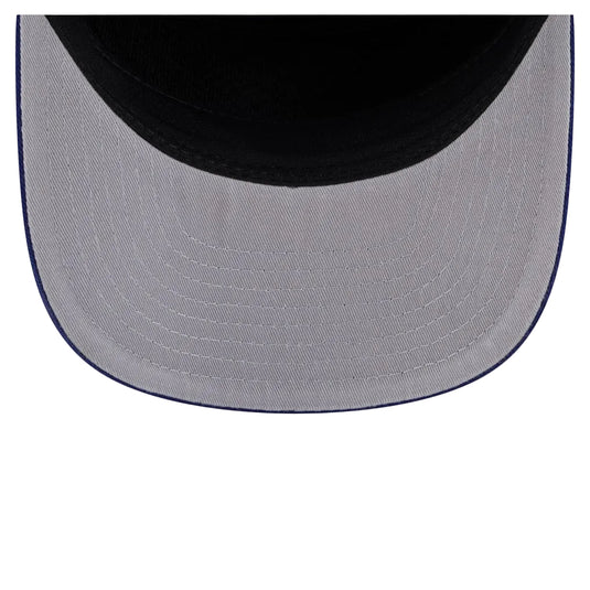 Close-up of the back of a baseball cap showing a light gray fabric brim with dark blue stitching and a black crown against a white background.