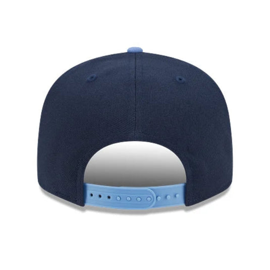 Back view of a New Era Dodgers snapback with a navy crown and light blue button and snapback closure