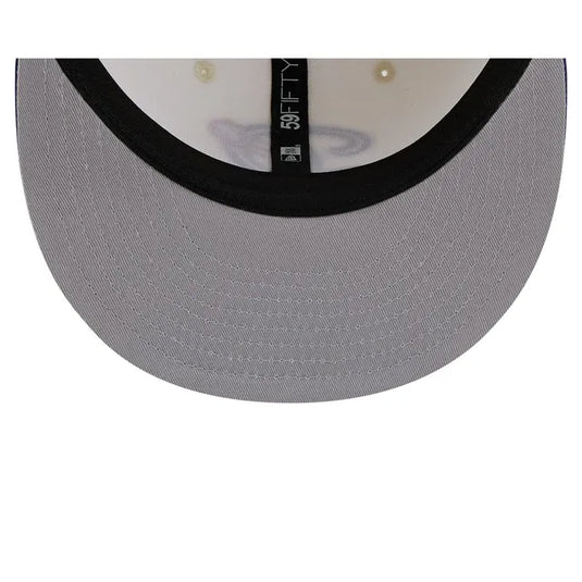 Close-up of the underside of a gray baseball cap showing the brim, black edge trim, and interior with pearl buttons and a black size tag reading 59FIFTY.