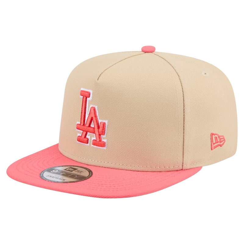 Load image into Gallery viewer, A New Era Los Angeles Dodgers 9FIFTY fitted cap featuring a beige crown with a red embroidered 'LA' logo and a bright coral pink flat brim.

