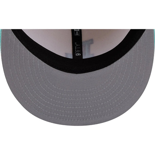 Close-up of the back of a baseball cap showing a gray fabric brim, black ribbed trim, and a black interior band with a visible New Era logo.