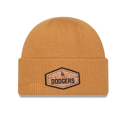 A mustard yellow ribbed knit beanie hat featuring a black and brown embroidered Los Angeles Dodgers patch on the front cuff, set against a plain white background.