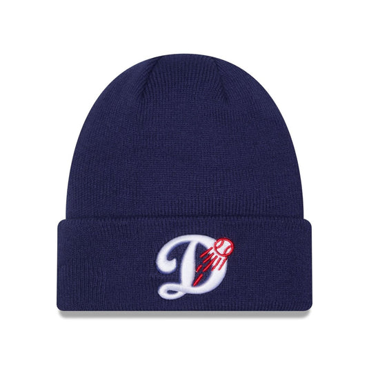 A navy blue ribbed knit beanie hat featuring a white embroidered script letter 'D' with a red baseball design on the front cuff, set against a plain white background.