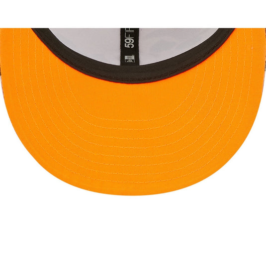 Close-up of an orange cap with a black rim on a white background