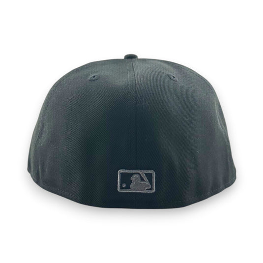Black baseball cap with a MLB logo on the back against a white background