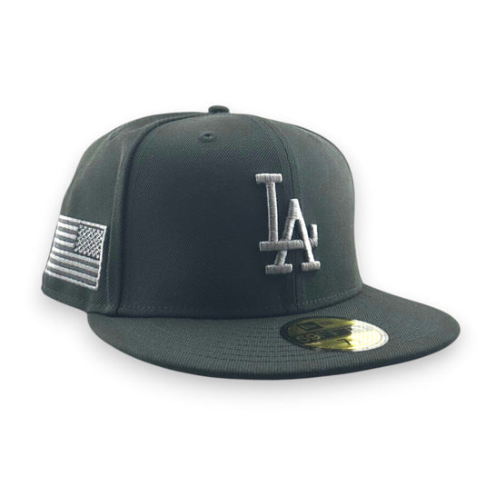 Black baseball cap with a graphite gray LA logo and American flag on a white background