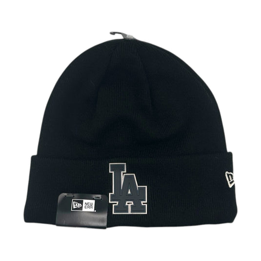 A black knit beanie hat featuring a large gray and white embroidered 'LA' logo on the front cuff, a small white New Era flag logo on the side, and a black hangtag attached to the front.