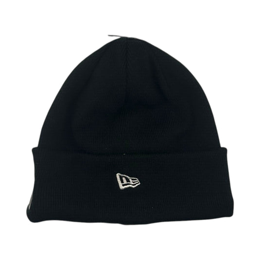 A black knit beanie hat with a folded cuff and a small white embroidered New Era flag logo on the front, shown against a plain white background.